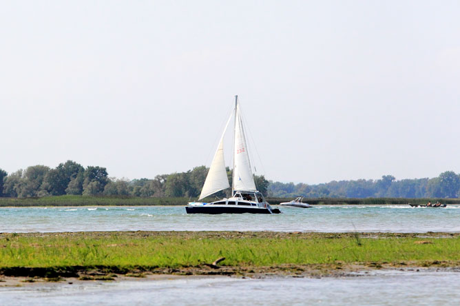 A sailboat and other pleasure craft on the St. Lawrence